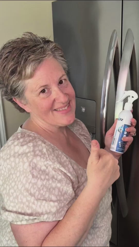 Wiping a stainless steel fridge with BLITZ ceramic coating