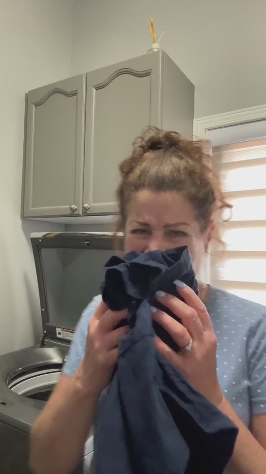 Dropping a BLITZ tablet into a top-load washer